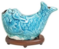 A TURQUOISE-GLAZED WATER DROPPER KANGXI (1662-1722) in the form of a 'dragon-fish', on a hardwood