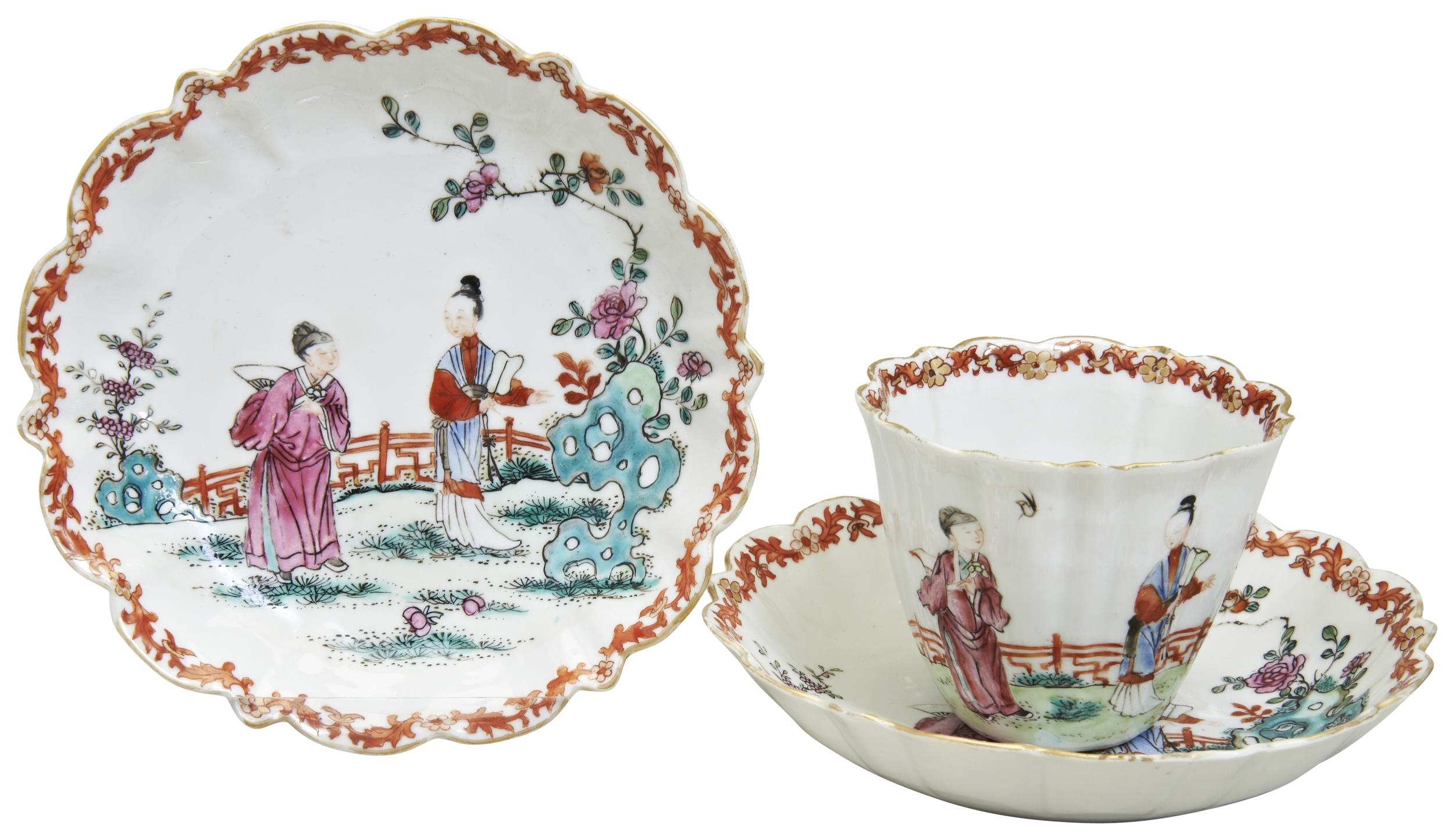 A FAMILLE ROSE CUP AND TWO SAUCERS QING DYNASTY, 18TH CENTURY  Depicting figures in a garden