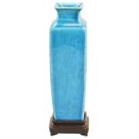 A TURQUOISE-GLAZED SQUARE VASE QING DYNASTY, 18TH CENTURY 清 孔雀绿釉方型瓶 raised on a hardwood stand,