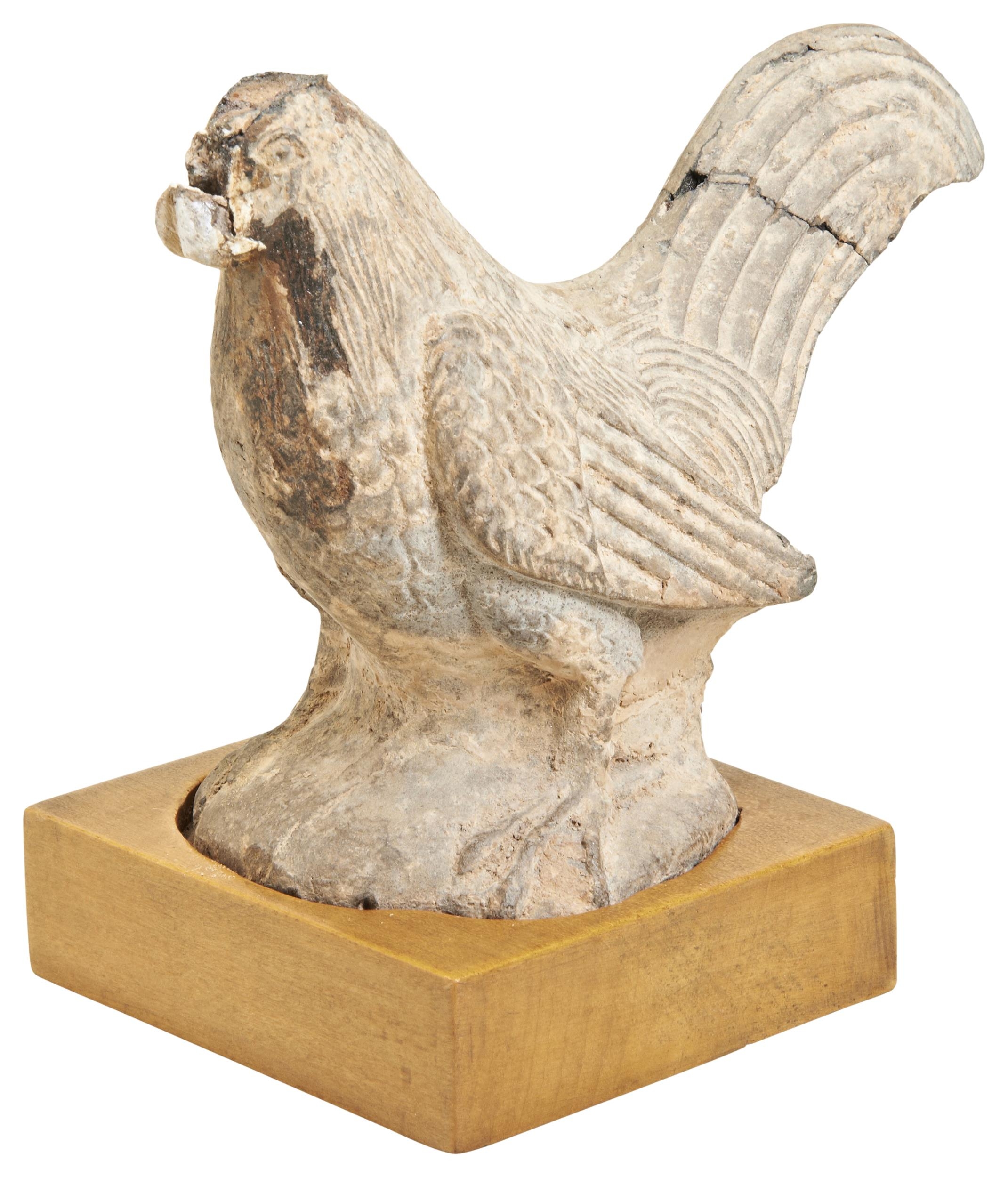 A POTTERY FIGURE OF A COCKEREL EASTERN HAN DYNASTY (AD. 25-227) on a wooden stand, within a fitted