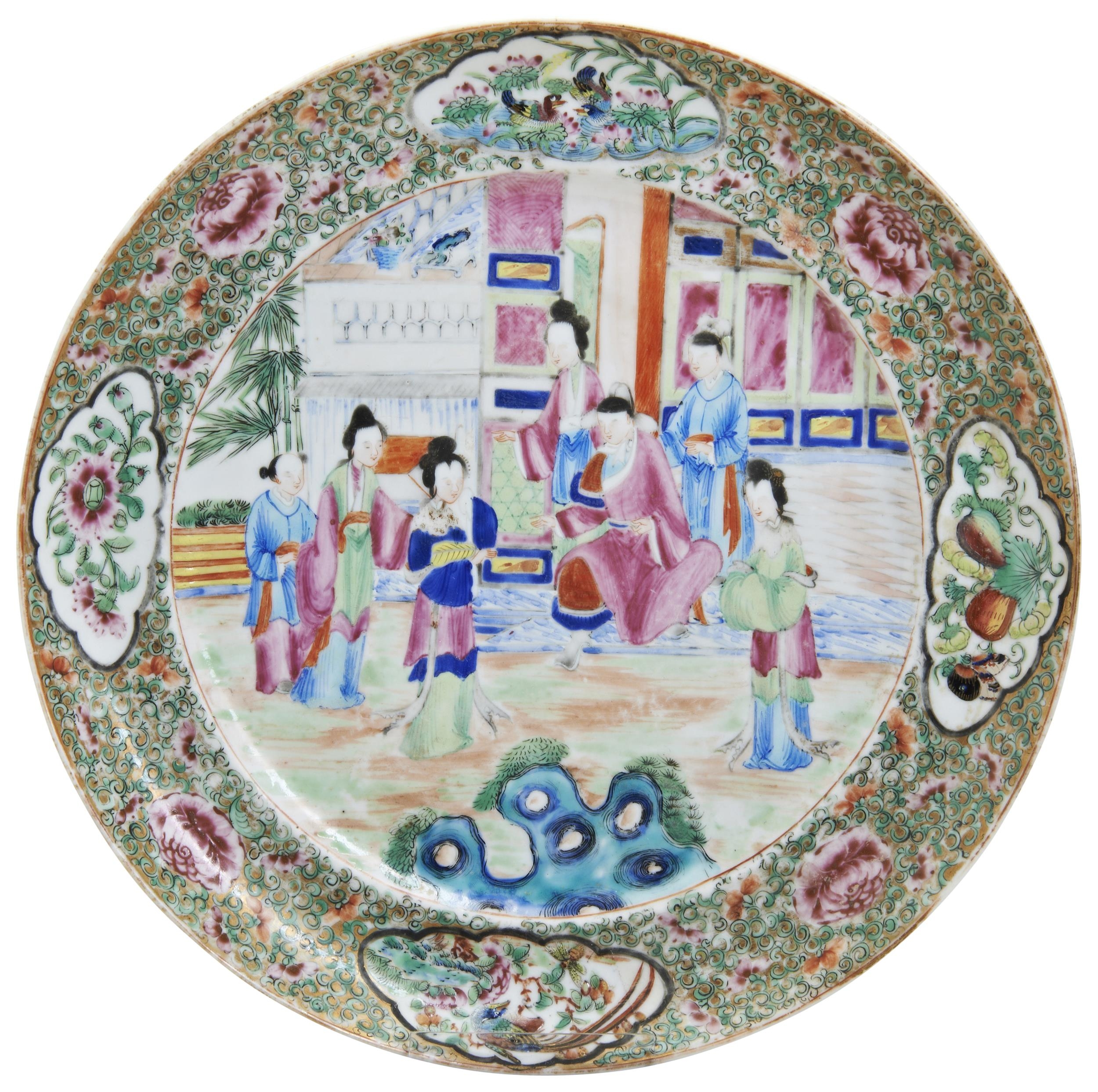 A FAMILLE ROSE CANTON DISH LATE QING DYNASTY decorated with an interior scene of courtiers 25cm diam