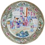 A FAMILLE ROSE CANTON DISH LATE QING DYNASTY decorated with an interior scene of courtiers 25cm diam