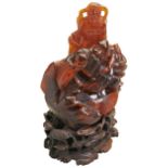 A CARVED AMBER FIGURE OF DAOIST IMMOTALS 19TH/20TH CENTURY  carved Daoist immortal 'Shoulao' holding