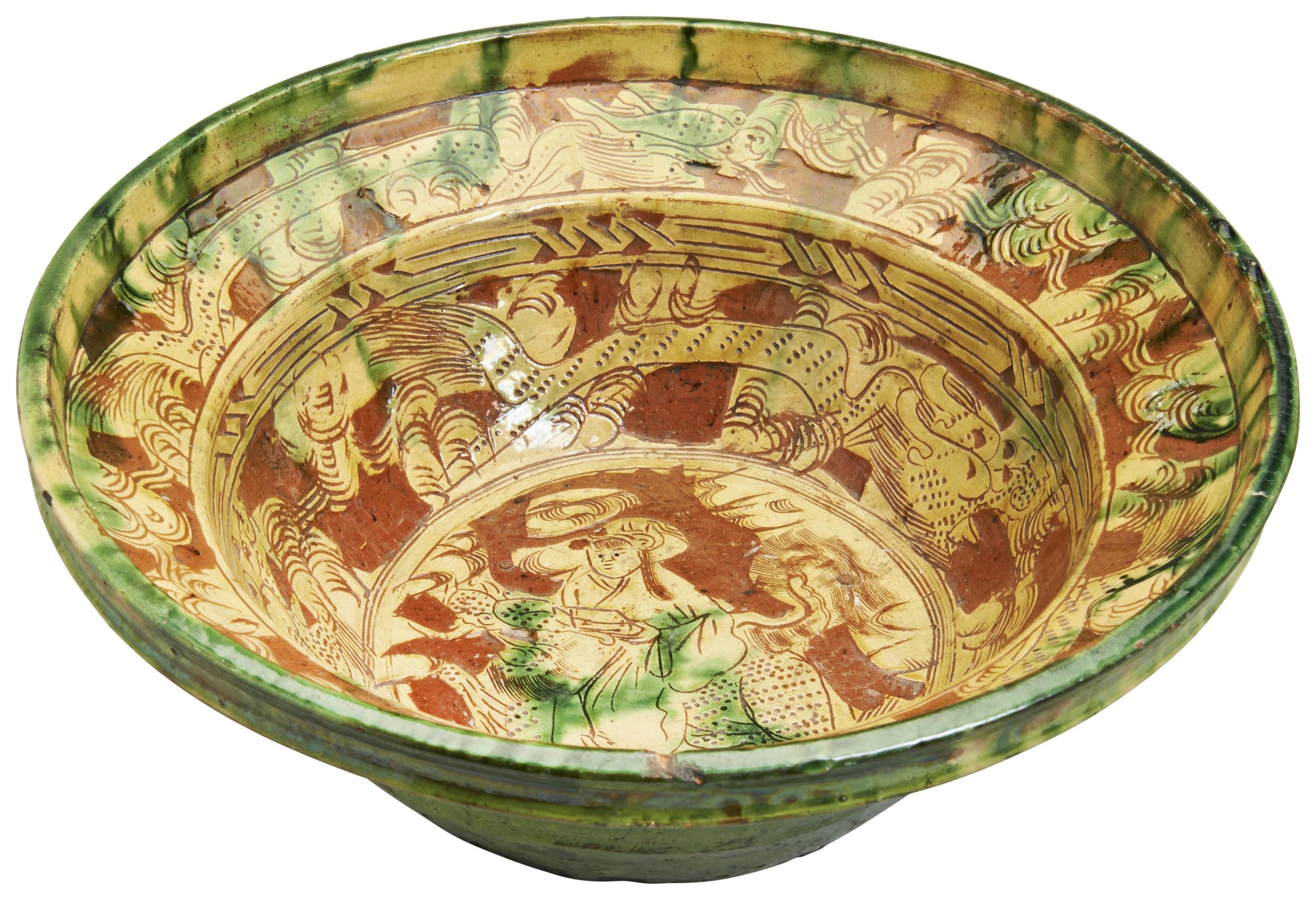 A LARGE SANCAI GLAZED BOWL LATE MING DYNASTY in the Persian-style, decorated with stylised dragons