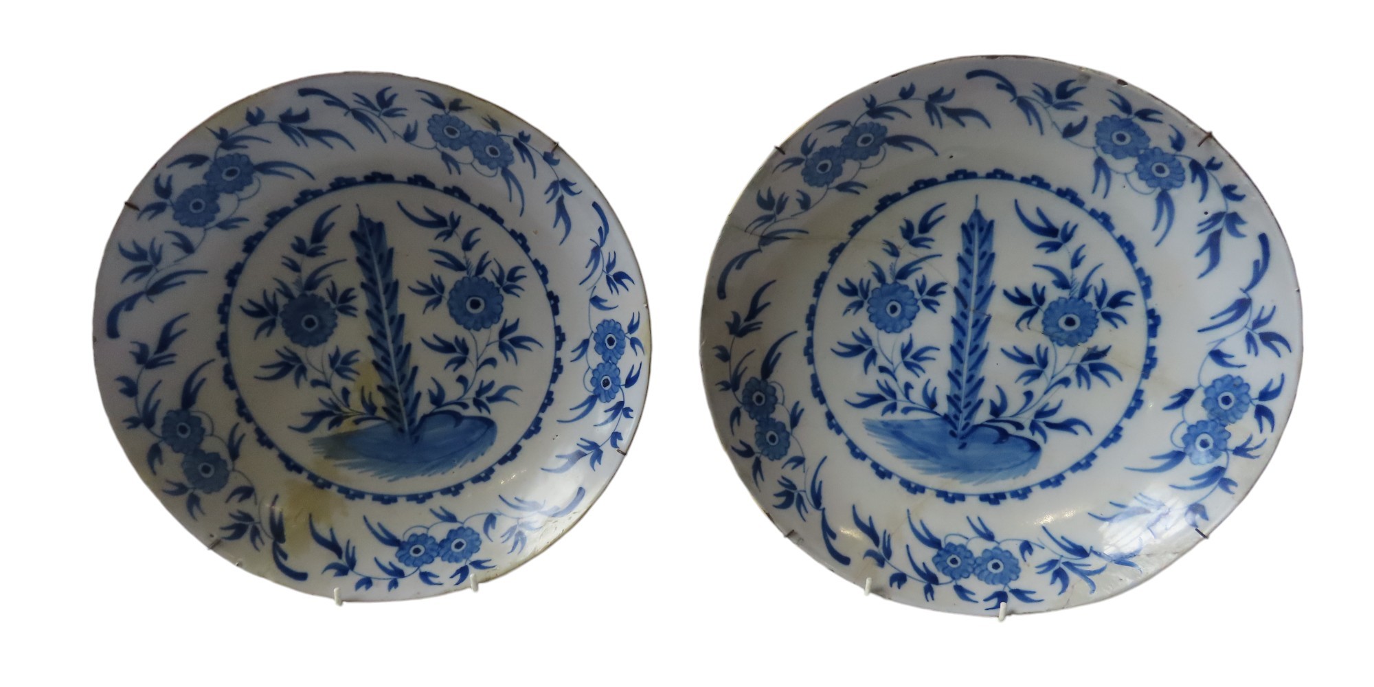 A PAIR OF 18TH CENTURY DUTCH TIN GLAZED CHARGERS, centrally reserved floral and foliate