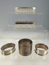 Three silver napkin rings and two silver lidded glass vanity pot, various makers and dates, silver g