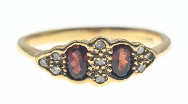 9ct gold ring set with orangey red paste and diamond accents. Size N 1/2. Gross weight 2.02g
