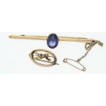 15ct gold bar brooch set with a purple paste stone, gross weight 3.43g, together with a small 9ct go