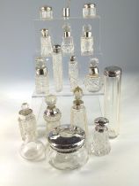 Sixteen silver topped glass vanity jars, various makers and dates