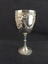 Large George V silver trophy cup, Jones & Crompton, Birmingham 1911, of chalice form, the body embos