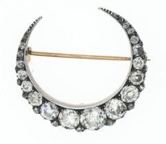 Victorian diamond crescent brooch. Featuring two rows of old European cut diamonds, principle diamon