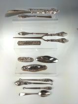 Three silver mounted nail buffers, silver handled glove stretcher, shoe horn, three hooks, three man