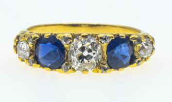 Yellow metal diamond and sapphire ring. The central old cut diamond measures approximately 5.5 x 5mm