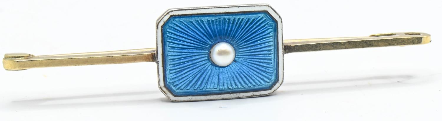 15ct gold bar brooch with a silver set enamel panel with central pearl. Gross weight 3.84g 