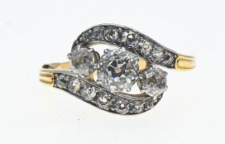 Diamond crossover ring with old European cut stones. Claw set with pavé set accents in white metal o