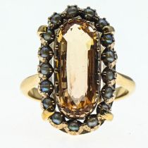 Imperial topaz ring. Central stone (15mm x 6mm) is surrounded by a halo of seed pearls and set in ye