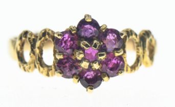 Pink sapphire, flower cluster ring on 9ct gold featuring openwork shoulders. Gross weight 2.27g