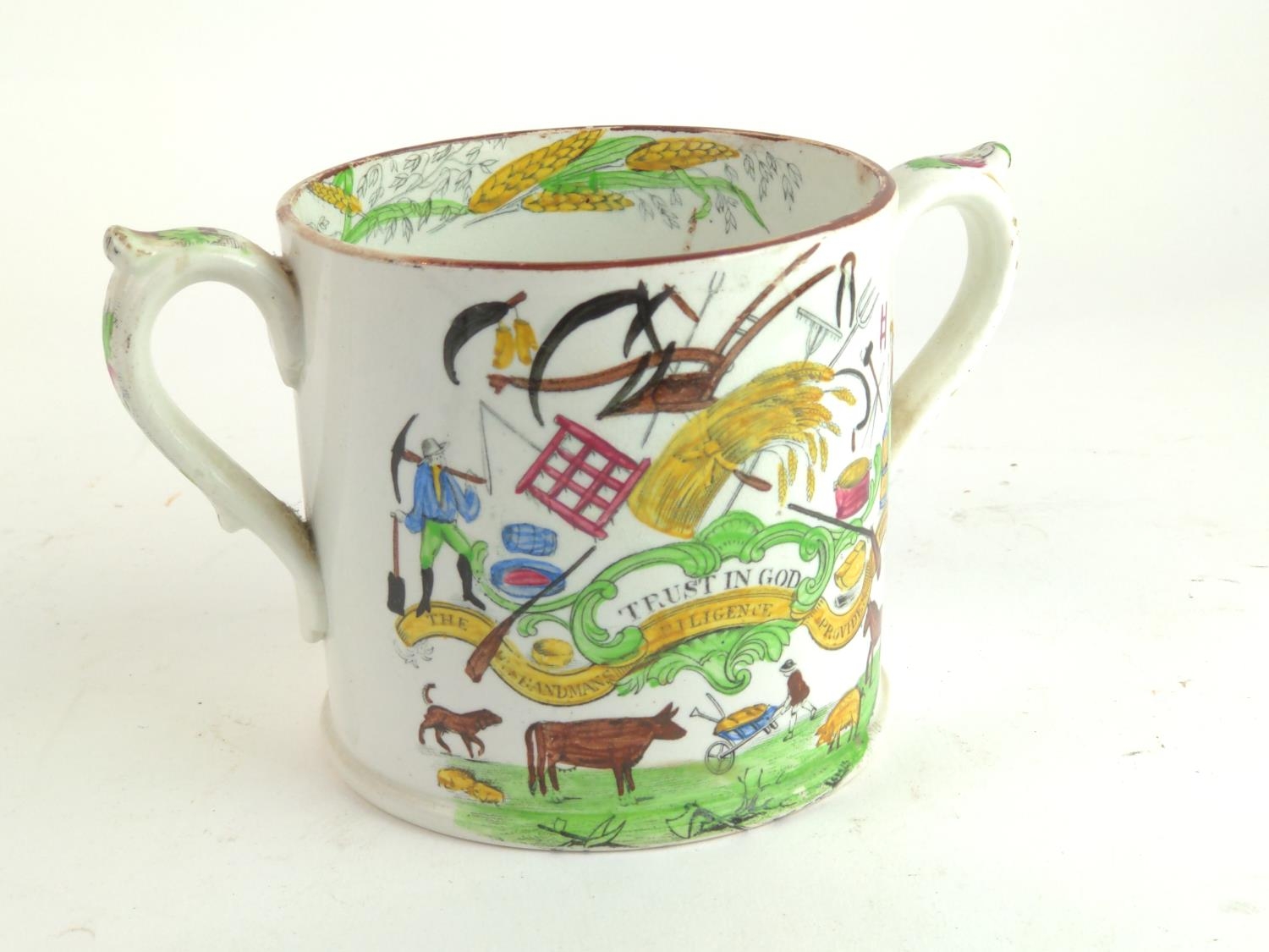 Staffordshire loving cup, with transfer printed farmers verse 'Trust in God' and implements, height 