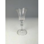 English 18th century wine glass, the bell-shaped bowl above a tear drop baluster stem, on a conical 