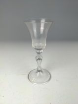 English 18th century wine glass, the bell-shaped bowl above a tear drop baluster stem, on a conical