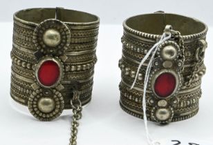 Yemeni or Bedouin white metal bangles set with red glass. D5cm H6cm