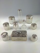 Ten embossed silver topped glass vanity jars, various makers and dates