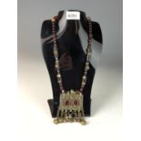 Yemeni or Bedouin white metal and beaded necklace with  pendant. Set with red glass and suspended be