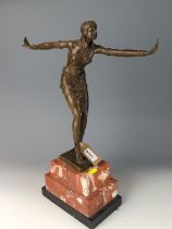 A contemporary Art Deco style brown patinated cast bronze figure of a Phoenician Dancer, base with c