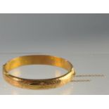 15ct gold hinged bracelet, engraved with flowers and scrolls to one side, hallmarked Birmingham 1918