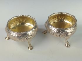 Pair of Edwardian silver circular salts, maker's mark rubbed, London 1909, each with foliate decorat