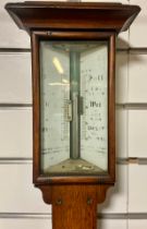 Edwardian stick barometer in oak casement showing Fahrenheit and Centigrade