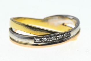 Tricoloured yellow metal crossover ring set with diamonds. Size O, gross weight 3.49g 