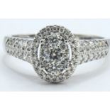 18ct white gold and diamond oval cluster ring, size R, gross weight 3.9 grams 
