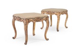 A PAIR OF CONTINENTAL CARVED GILTWOOD STOOLS