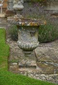 A PAIR OF STONE COMPOSITION CAMPANA URNS