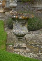 A PAIR OF STONE COMPOSITION CAMPANA URNS