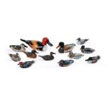 A COLLECTION OF APPROXIMATELY TWELVE CARVED AND PAINTED WOOD MODELS OF DUCKS