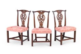 A SET OF THREE GEORGE III CARVED MAHOGANY CHAIRS, IN THE MANNER OF THOMAS CHIPPENDALE
