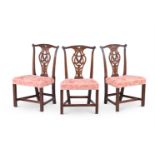 A SET OF THREE GEORGE III CARVED MAHOGANY CHAIRS, IN THE MANNER OF THOMAS CHIPPENDALE