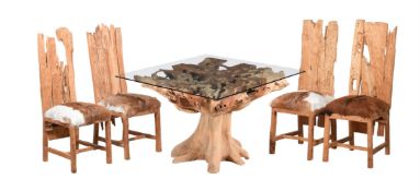 A DRIFTWOOD EFFECT AND GLASS TOPPED PEDESTAL TABLE AND FOUR RUSTIC CHAIRS EN-SUITE