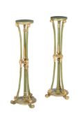 A PAIR OF GREEN PAINTED AND PARCEL GILT TORCHERE STANDS IN GEORGE III STYLE