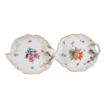 A PAIR OF MEISSEN FLOWER ENCRUSTED LEAF-SHAPED SERVING DISHES