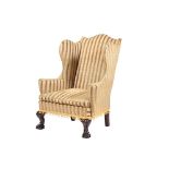 A CARVED MAHOGANY WING ARMCHAIR IN GEORGE III STYLE