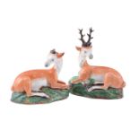 A PAIR OF STAFFORDSHIRE PEARLWARE MODELS OF RECUMBENT DEER