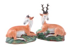 A PAIR OF STAFFORDSHIRE PEARLWARE MODELS OF RECUMBENT DEER