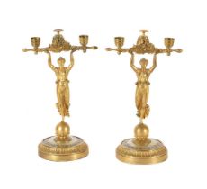 Y A PAIR OF GILT METAL FIGURAL CANDLESTICKS