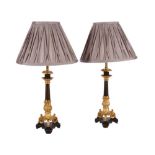 A PAIR OF GILT AND PATINATED METAL TRIFORM CANDLESTICKS