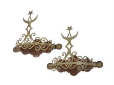 A PAIR OF STAINED WOOD AND PATINATED METAL BED CROWNS
