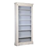 A LARGE CREAM PAINTED OPEN BOOKCASE