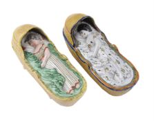 A STAFFORDSHIRE PEARLWARE MODEL OF A CHILD AND CRADLE OF PRATT FAMILY TYPE